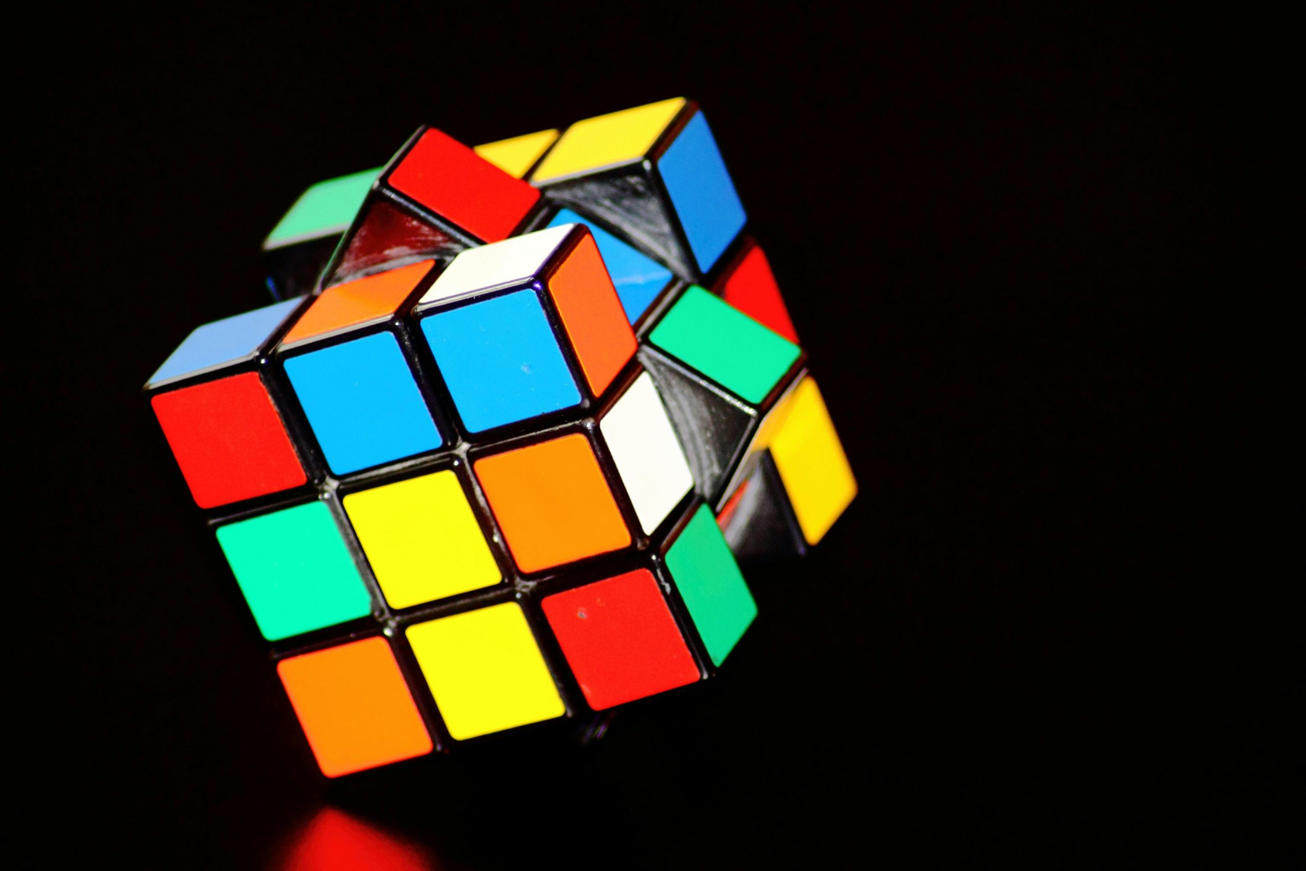 A close-up of a colorful Rubik's Cube puzzle, showcasing concentration and play.