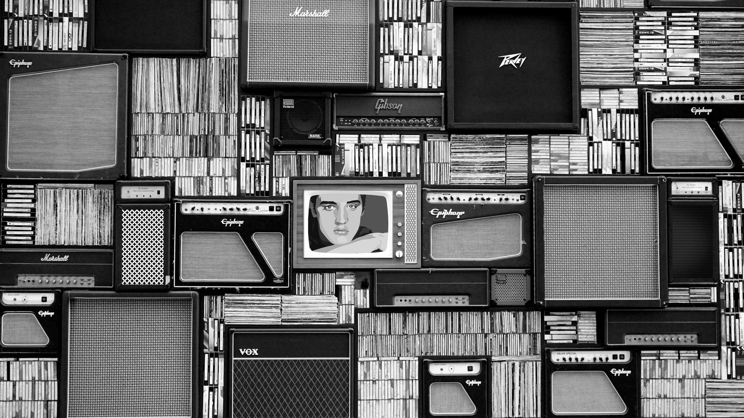 Vintage amplifiers and vinyl records arranged in a striking black and white pattern.