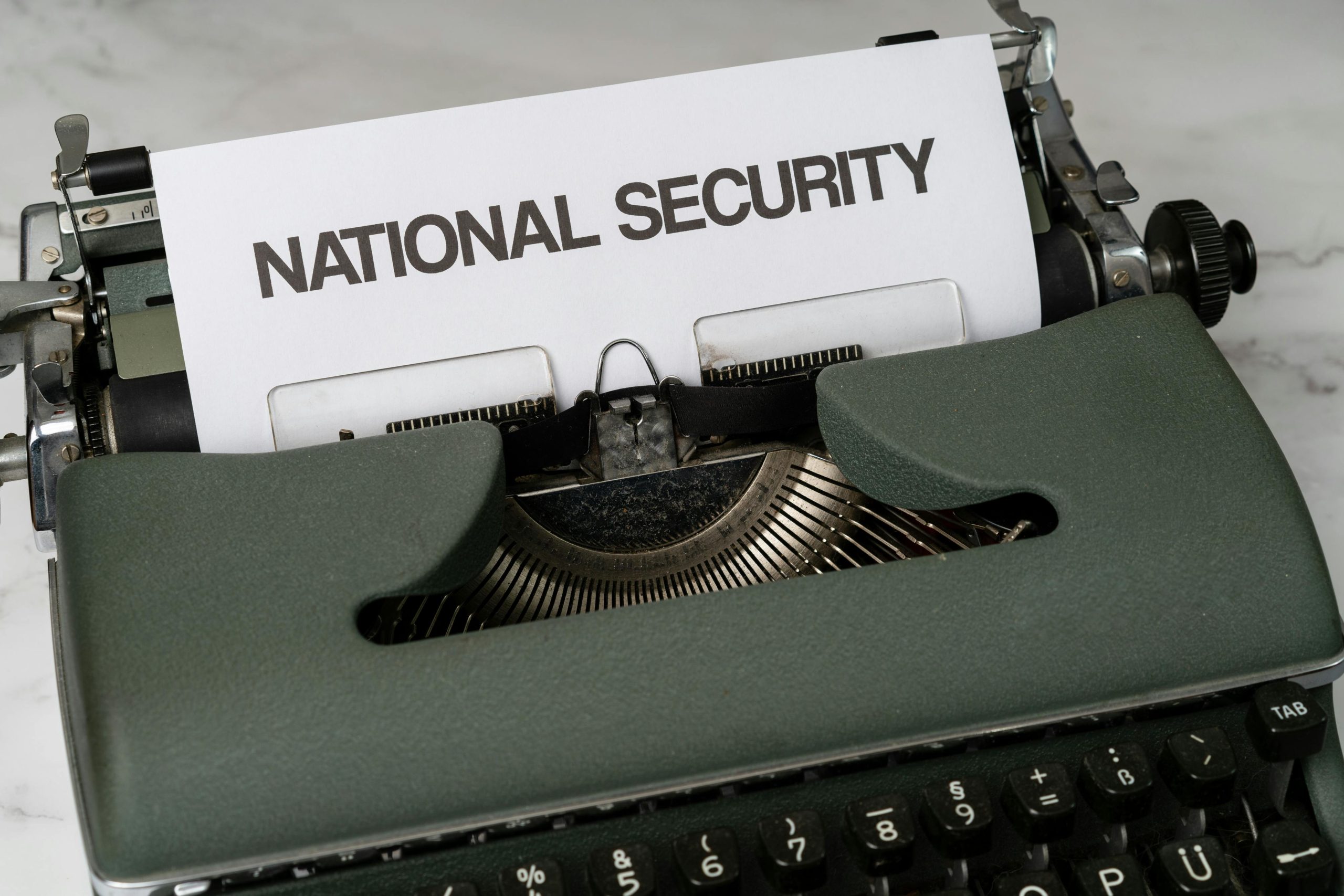 Close-up of a vintage typewriter with a paper marked 'National Security', symbolizing confidentiality.