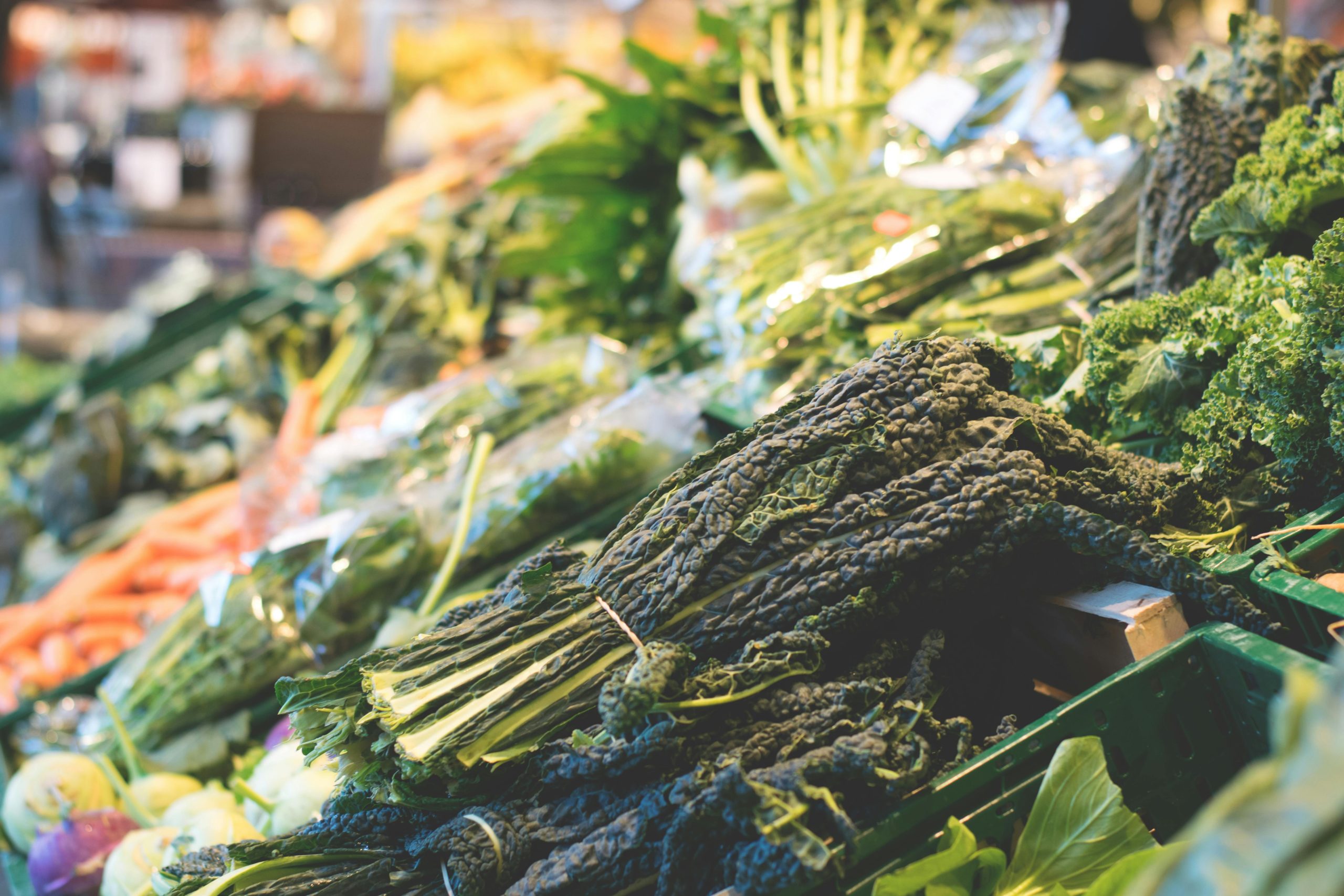 A vibrant display of fresh organic vegetables at a local market stall, showcasing healthy eating.