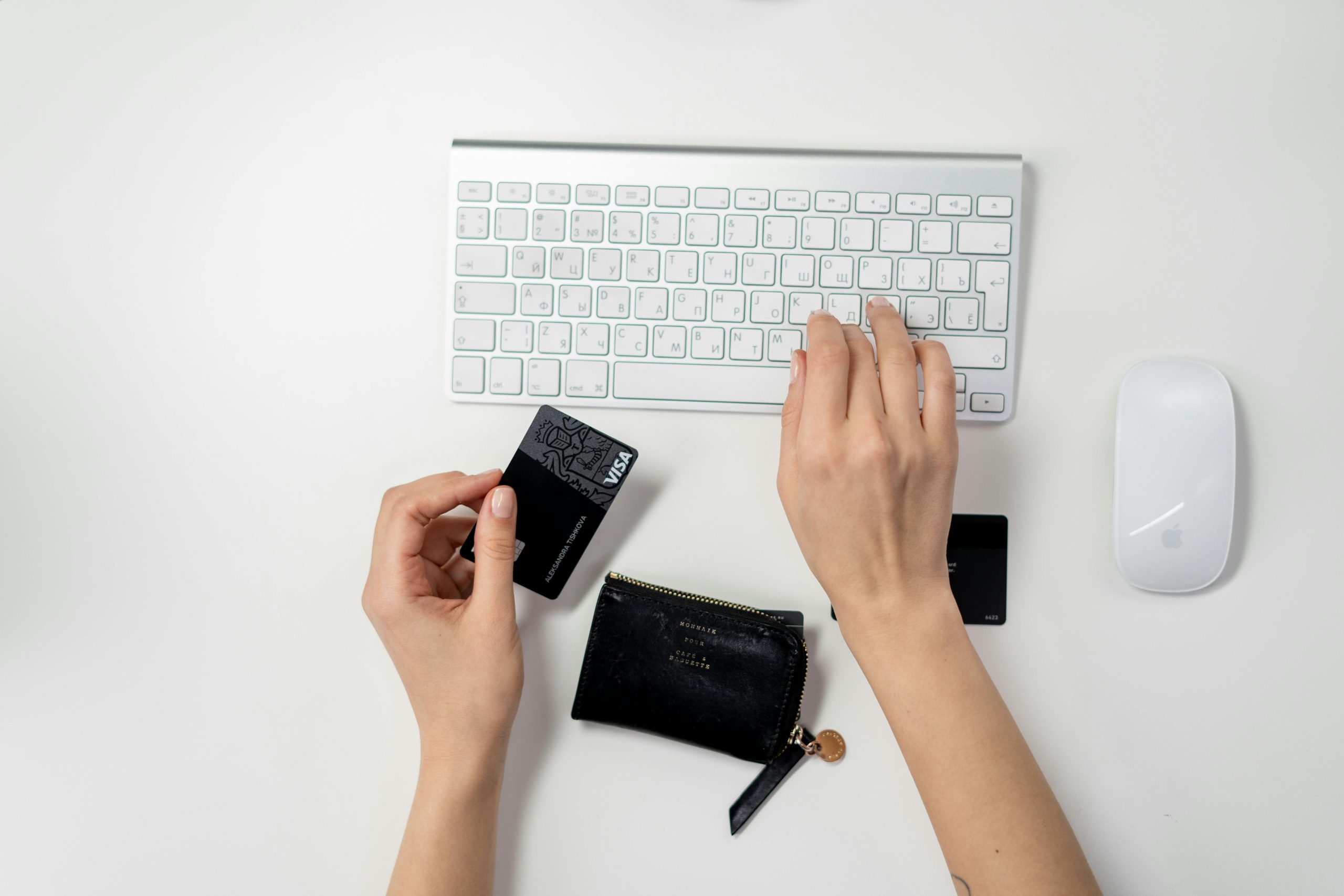 E-commerce setup featuring a keyboard, card, and wallet, ideal for online shopping concepts.