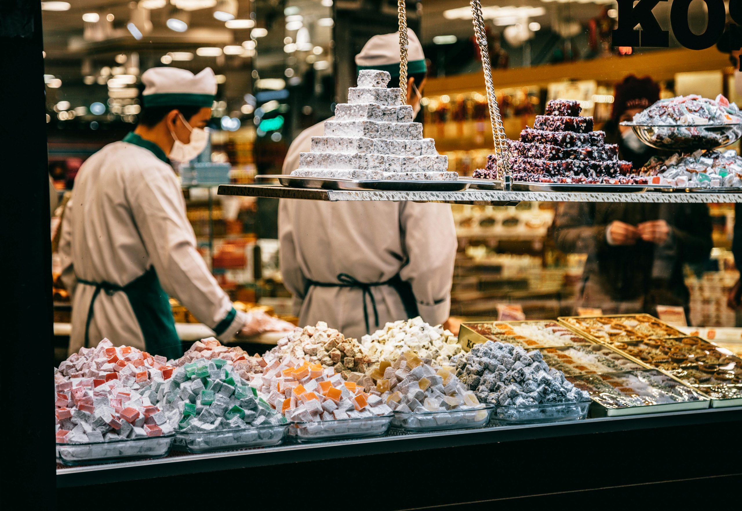 Colorful assortment of Turkish delight in a lively Istanbul market sweets shop.