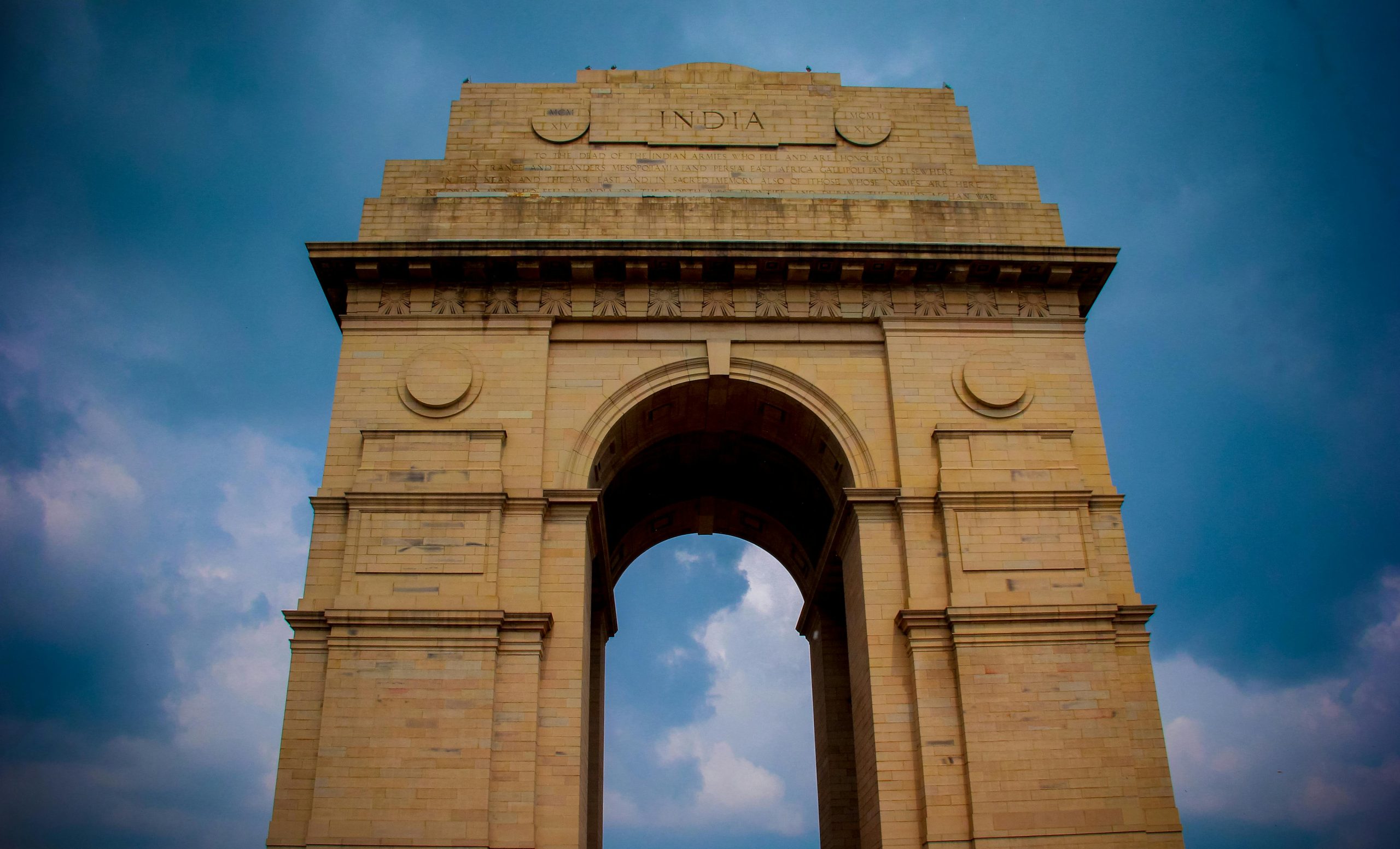 Majestic view of India Gate under a vibrant blue sky in New Delhi, India.