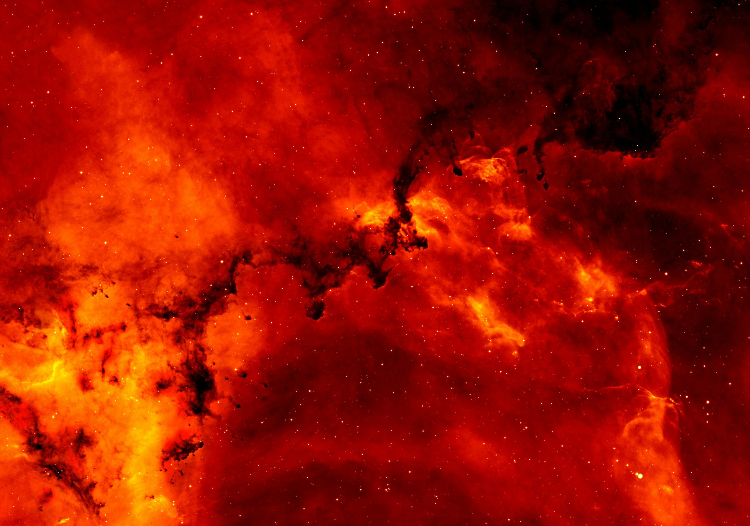 A stunning view of a red cosmic nebula, glowing intensely against a backdrop of stars.